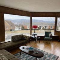 prestige residential window films on massive windows in a street-facing living room